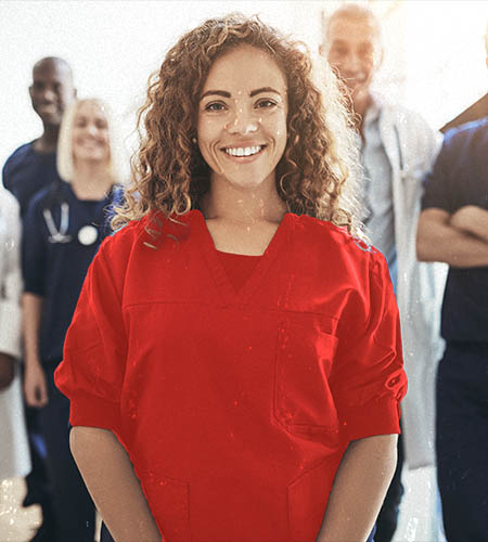 "A nurse in red scrubs smiling"